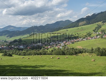 View On Village Liptovska Luzna At The Foothills Of Low Tatras Mountains With Lush Green Meadow, For