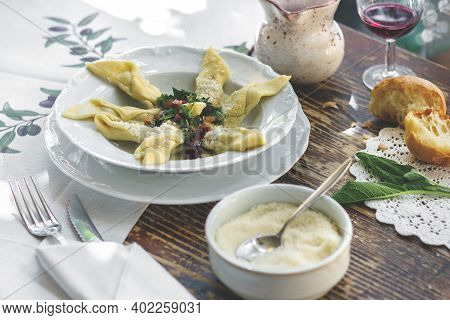 Delicious Italian Fresh Casoncelli Served On Rustic Wooden Table With Homemade Bread And Red Wine. C
