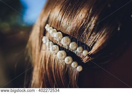 Pearl And Filagree Hair Clasp In Beautiful Long Reddish Brown Hair - Close Up.