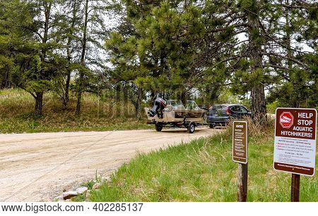 Clearwater Co, Mn - 23 May 2020: Automobile Car Pulls Fishing Boat And Trailer On A Gravel Road Near