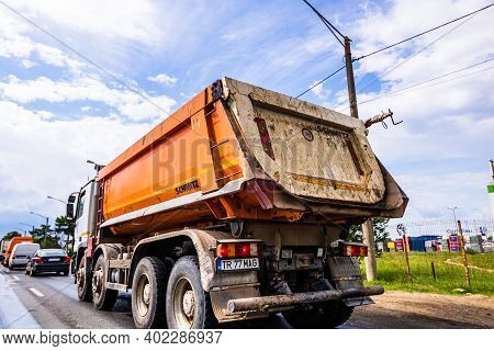 Traffic With Road View Through Car Front Window, Dirty Schmitz Cargobull Tipper Trailer Truck In Tra