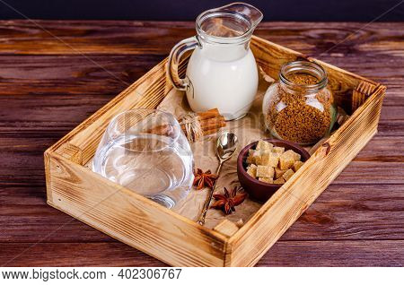 Ingredients For Dalgon Coffee In A Box On A Wooden Background. Instant Coffee, Anise, Cinnamon, Cane