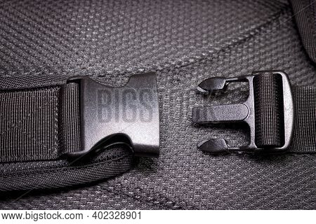 Black Plastic Buckle On The Backpack. Plastic Zip Lock. Close-up.