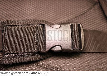 Black Plastic Buckle On The Backpack. Plastic Zip Lock. Photo Toned Sepia. Close-up.