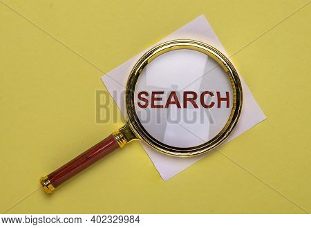 Search Word Through Magnifying Glass On Trendy Yellow Background