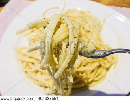 Italian Housewife With Traditional Manual Sheeter Rolls Egg Pasta, The Color Of The Sun Of Italy, Ma