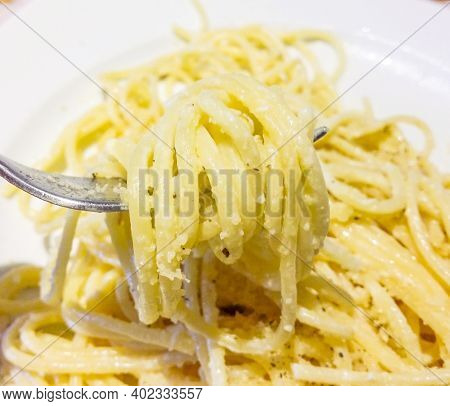 Italian Housewife With Traditional Manual Sheeter Rolls Egg Pasta, The Color Of The Sun Of Italy, Ma