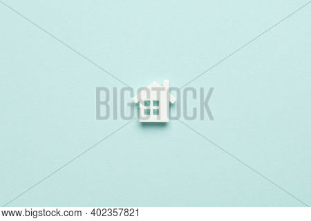 Miniature House On Light Blue Mentol Background. Top View. Buy Of Property, Home, Real Estate. Affor