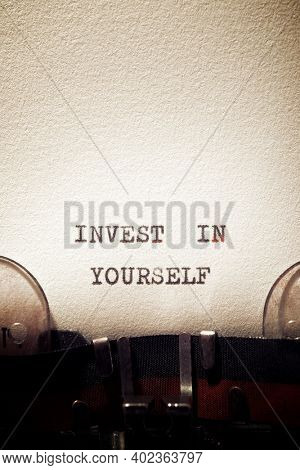 Invest in yourself phrase written with a typewriter.
