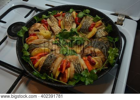 Grilled Salmon Fish With Various Vegetables On Pan On The Flaming Grill