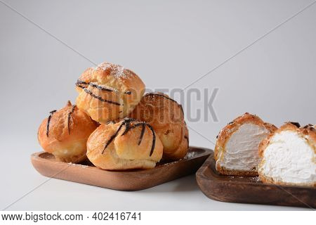Eclair Drenched In Chocolate Stuffed With White Crème