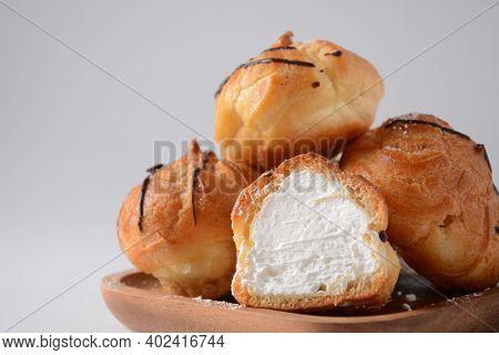 Eclair Drenched In Chocolate Stuffed With White Crème