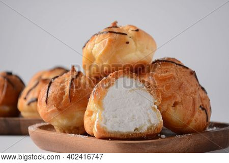Eclair Drenched In Chocolate Stuffed With White Crème