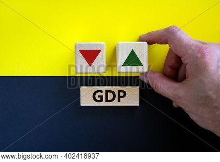 Gdp, Gross Domestic Product Symbol. Businessman Holds A Cube With Up Icon. Wooden Block With Word 'g