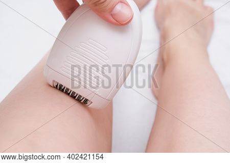 Unwanted Extra Hair Removal, Woman Epilating, Depilating Legs With An Electric Epilator Close Up, Ho