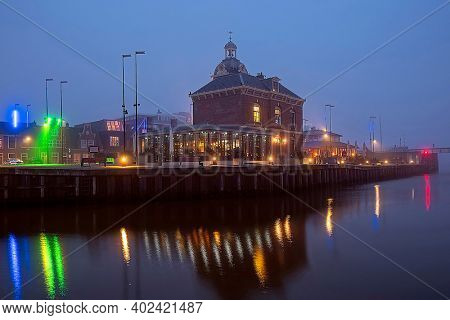 Medieval traditional building in the city Harlingen in the Netherlands at sunset
