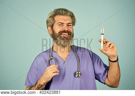 Coronavirus Epidemic From China. Mature Doctor Use Syringe In Hospital . Skilled Nurse Make Injectio