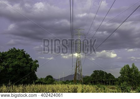 Electricity Pole With Green Corn Fields Against Silhouette Sunset Sky, Electricity Pylon With Shadow