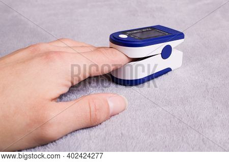 Pulse Oximeter On Hinger On Gray Background Close Up