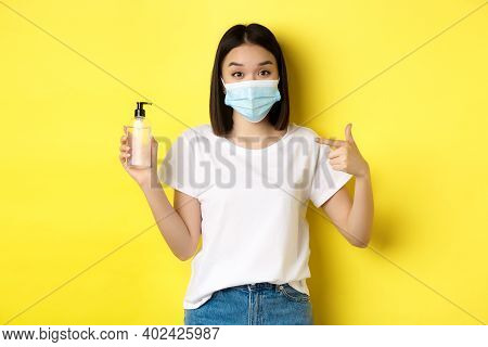 Covid, Health Care And Pandemic Concept. Asian Girl In Face Mask From Coronavirus, Pointing Finger A