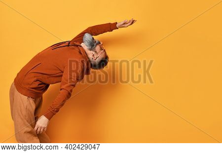 Strong Brutal Grey-haired Bearded Man Wearing Sportswear And Trendy Sunglasses Bending Backwards. Sp