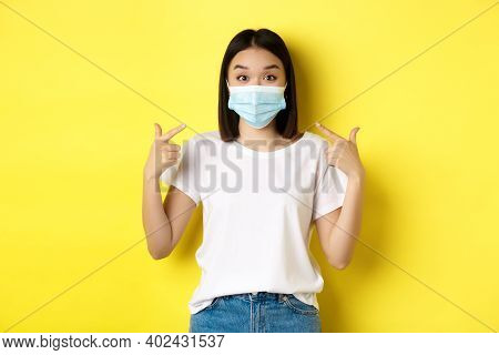 Covid-19, Quarantine And Social Distancing Concept. Young Asian Woman In White T-shirt, Pointing At 