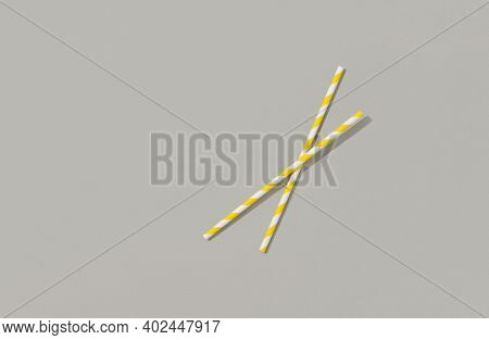 Two Yellow Paper Straw On Gray Background