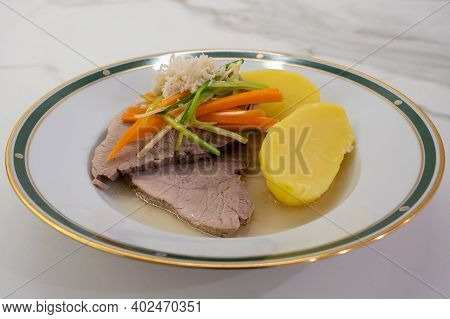 Stewed Pork With Root Vegetable Julienne Of Carrots, Leeks, Horseradish And Potatoes Called Steirisc