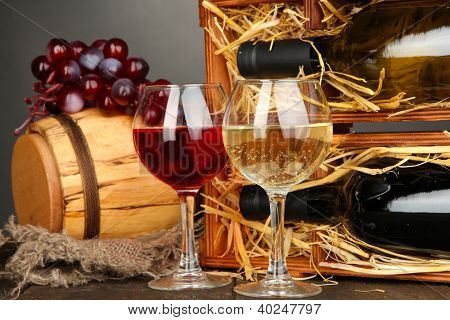 와인 병, 배럴, 글래스와 회색 배경에 나무 테이블에 포도 나무 케이스