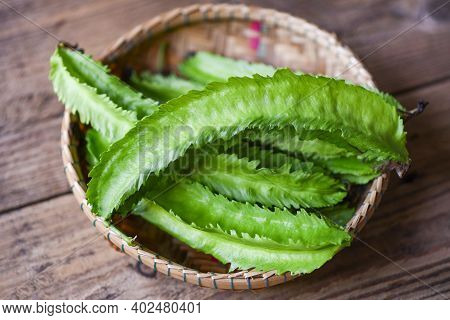 Wing Bean On Basket And Wooden Table Background, Young Winged Beans Vegetable