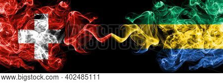 Switzerland, Swiss Vs Gabon, Gabonese, Gabonian Smoky Mystic Flags Placed Side By Side. Thick Colore