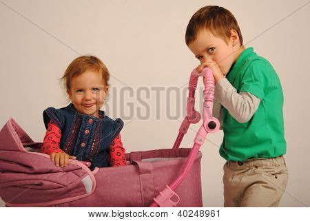 Two kids with a carriage.
