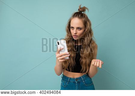 Photo Shot Of Beautiful Serious Good Looking Young Woman Wearing Casual Stylish Outfit Poising Isola