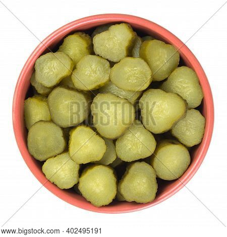 Chopped Gherkins In A Brown Cup Isolated On White Ba?kground. Top View.