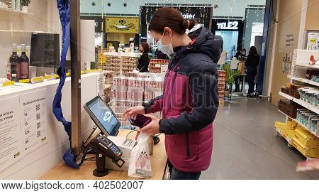 Russia, St. Petersburg 02.01.2021 Buyer In A Mask At A Self-checkout Counter During The Coronavirus 
