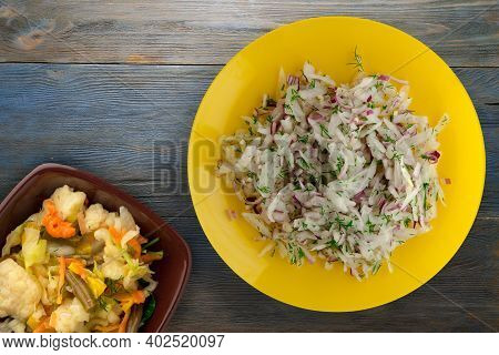 Salad Daikon, Onions And Dill On Blue Grey Wooden Background. Salad On Yellow  Plate With Vegetarian
