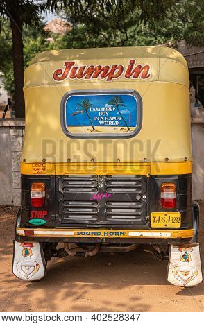 Hampi, Karnataka, India - November 5, 2013: Zanana Enclosure. Back Of Black-yellow Tricycle Taxi Wit