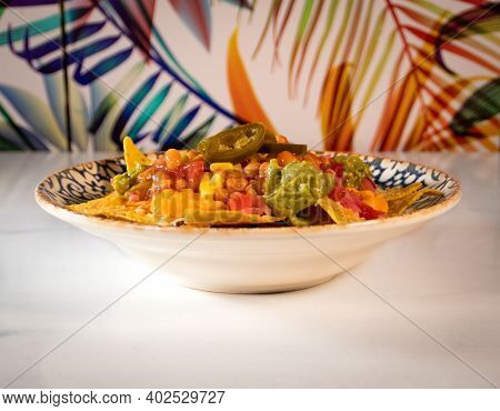 Traditional Mexican Food. Nacho Plate With Chili, Beans And Corn.