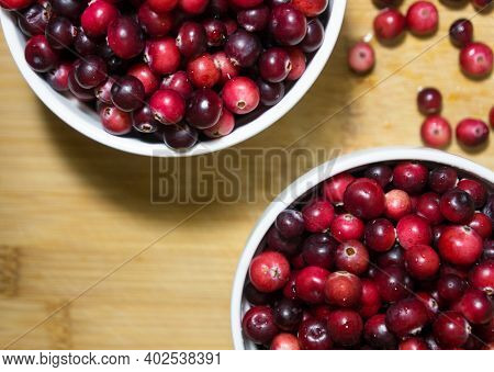 Red Berries Cranberries. Fresh Berries In Light Utensils On A Wooden Background. Berries. Vitamins.