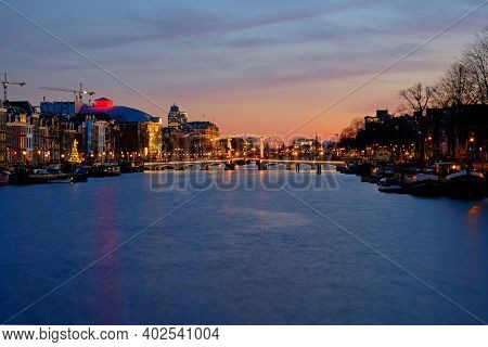 Tiny bridge in Amsterdam the Netherlands at sunset at the Amstel