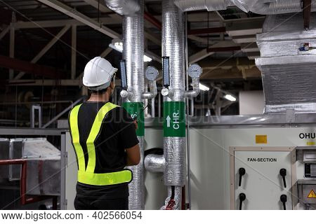 Technician Daily Pressure Check Controls System For Security Functions In Utility Room At Factory. C