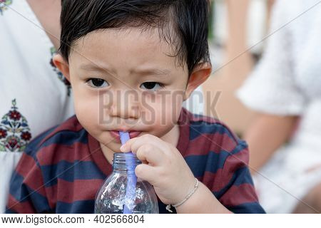 Portrait Of Asian Little Boy While Water Drinking After Playing At The Park On The Playground For Ki