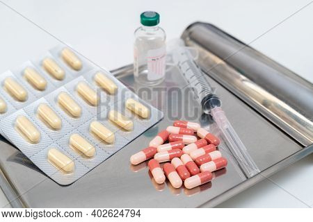 Anti-coronavirus Drugs And Vaccine With Syringe, Medicine And Drug Concept.