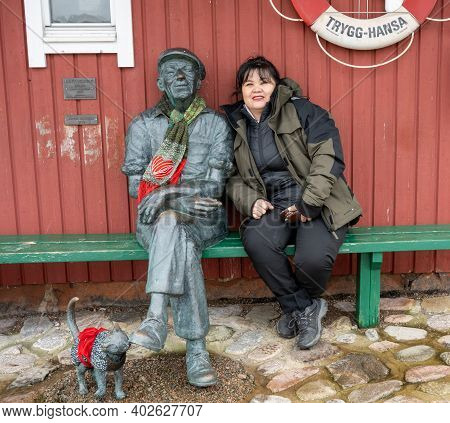 December 19, 2020 - Molle, Sweden: A Middle-aged Asian Woman Sit Close Together With A Fisherman Scu