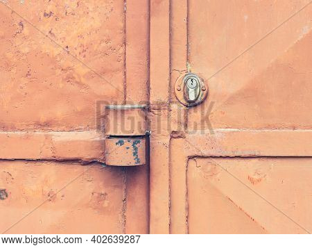 Red Locked Old Metal Door. Massive Lock Case On Latch And Lock Insert. Industrial Sheet Metal Doors 