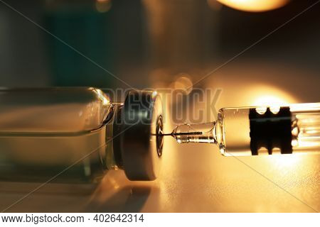 Filling Syringe With Vaccine From Vial On Table, Closeup