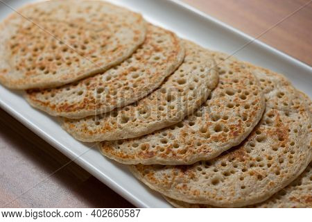 Derbyshire Oatcakes Viewed From The Side On A White Platter