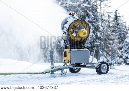Snow Cannon Gun Or Machine Sprays Water And Snowes A Ski Or Cross-country Track