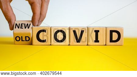 Mutated Covid Symbol. Male Hand Turns A Cube And Changes Words 'old Covid' To 'new Covid'. Beautiful