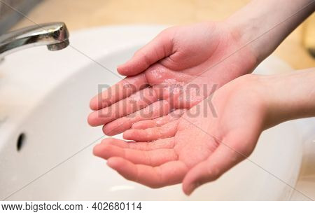 Teenager. Washing Hands In The Bathroom Sink. Frequent Hand Washing Is A Prerequisite For Good Hygie